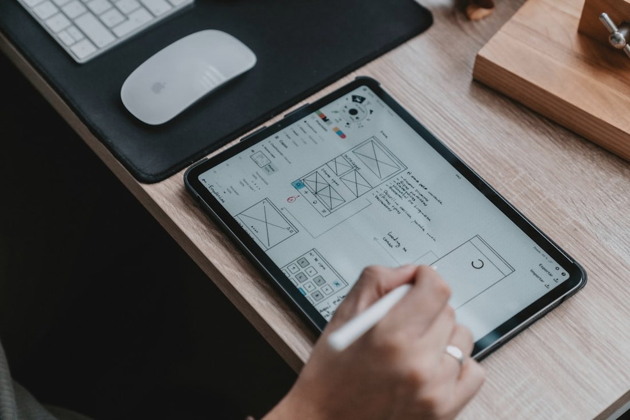 A BLNK designer sketching website wireframes on a tablet